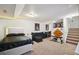 Comfortable bedroom featuring a seating area, adjacent stairs, and modern decor for a cozy and stylish space at 21111 E 43Rd Ave, Denver, CO 80249