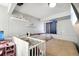 Bedroom featuring a crib, comfy bed with a teddy bear, and a modern TV at 21111 E 43Rd Ave, Denver, CO 80249