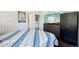 Bedroom featuring a queen-size bed, dresser, a TV, and a modern design at 21111 E 43Rd Ave, Denver, CO 80249