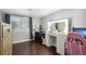 Bedroom featuring a makeup vanity with lighted mirror, computer desk, and dark laminate flooring at 21111 E 43Rd Ave, Denver, CO 80249