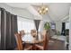 Bright dining area featuring hardwood floors, vaulted ceilings and views to living room and backyard at 21111 E 43Rd Ave, Denver, CO 80249
