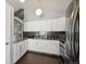 Bright kitchen showcasing white cabinets, stainless steel appliances, modern lighting, and easy access to stairs at 21111 E 43Rd Ave, Denver, CO 80249
