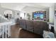 Open concept living room featuring hardwood floors, vaulted ceiling, and modern gray furniture set at 21111 E 43Rd Ave, Denver, CO 80249