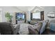 Cozy living room featuring gray furniture, vaulted ceiling, large window, and a decorative entertainment center at 21111 E 43Rd Ave, Denver, CO 80249