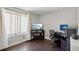 Home office space featuring a desk, monitor, office chair, and window with light-filtering curtains at 21111 E 43Rd Ave, Denver, CO 80249