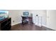 Spacious office featuring a desk, monitor, office chair, and dark laminate flooring at 21111 E 43Rd Ave, Denver, CO 80249