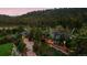 Aerial view of an estate nestled amongst mature trees, offering privacy and scenic views of the surrounding landscape at 97 Soda Creek Rd, Evergreen, CO 80439