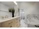 Elegant bathroom featuring marble floors and walls, a soaking tub, double vanity, and modern fixtures at 97 Soda Creek Rd, Evergreen, CO 80439