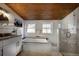 Bright bathroom with a soaking tub, granite counters, modern fixtures, and views from the windows, creating a spa-like experience at 97 Soda Creek Rd, Evergreen, CO 80439