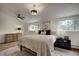 Well-lit bedroom with a ceiling fan, neutral walls, and large windows providing ample natural light and exterior views at 97 Soda Creek Rd, Evergreen, CO 80439