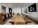 Spacious dining room featuring a long wooden table, brick accents, and ample natural light at 97 Soda Creek Rd, Evergreen, CO 80439
