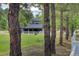 Exterior shot of home backed by a white fence surrounded by natural trees at 97 Soda Creek Rd, Evergreen, CO 80439