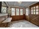 Inviting foyer featuring patterned marble floors, elegant wood paneling, and a stylish accent table at 97 Soda Creek Rd, Evergreen, CO 80439