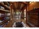Hallway featuring hardwood floors, a bookshelf and natural light from a distant window at 97 Soda Creek Rd, Evergreen, CO 80439