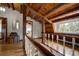 Hallway with wood beams, railing, and staircase featuring rustic wood floors and natural light at 97 Soda Creek Rd, Evergreen, CO 80439