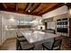 Beautiful kitchen featuring exposed beams, white cabinetry, a large island, and modern appliances at 97 Soda Creek Rd, Evergreen, CO 80439