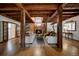 Inviting living room with exposed wooden beams, a cozy fireplace, and comfortable seating at 97 Soda Creek Rd, Evergreen, CO 80439