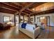 Bright living room featuring exposed beams, hardwood floors, a leather armchair, and lots of seating at 97 Soda Creek Rd, Evergreen, CO 80439