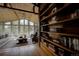Bright living room with large windows, a vaulted wood ceiling, built-in bookcase and comfortable seating at 97 Soda Creek Rd, Evergreen, CO 80439