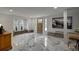 Bright, open-concept living room with marble floors, brick accents and bay window at 97 Soda Creek Rd, Evergreen, CO 80439