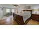 Spacious main bedroom with wood floors, a large bed, and bright windows providing natural light at 97 Soda Creek Rd, Evergreen, CO 80439