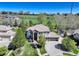 Expansive property featuring lush greenery, a spacious driveway, and a well-manicured lawn at 12825 W 81St Ave, Arvada, CO 80005