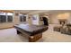 Finished basement with fireplace, a pool table, and recessed lighting at 12825 W 81St Ave, Arvada, CO 80005