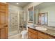 Updated bathroom featuring glass enclosed shower, and a vanity with drawers for storage at 12825 W 81St Ave, Arvada, CO 80005