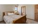 Comfortable bedroom with neutral colors, plush carpeting, and natural wood doorframes and trim at 12825 W 81St Ave, Arvada, CO 80005