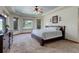 Main bedroom featuring a trey ceiling, carpeting, and multiple windows with outside views at 12825 W 81St Ave, Arvada, CO 80005