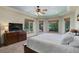 Main bedroom featuring a trey ceiling, carpeting, and multiple windows with outside views at 12825 W 81St Ave, Arvada, CO 80005