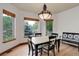 Bright dining area featuring hardwood floors, large windows, and backyard views at 12825 W 81St Ave, Arvada, CO 80005