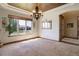 The dining room boasts natural light, a decorative ceiling, and a view of the lush neighborhood at 12825 W 81St Ave, Arvada, CO 80005