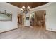 An elegant dining room featuring an arched entryway, a large mirror, and views to the front entry at 12825 W 81St Ave, Arvada, CO 80005