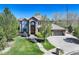 Stunning two-story home with lush landscaping, stone accents, a tile roof, and a spacious three-car garage at 12825 W 81St Ave, Arvada, CO 80005