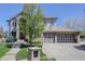 Charming two-story house with a well-maintained lawn, and a convenient three-car garage at 12825 W 81St Ave, Arvada, CO 80005