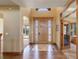 Elegant entryway featuring a stunning wooden door, beautiful tile flooring, and high ceilings at 12825 W 81St Ave, Arvada, CO 80005