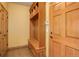 Welcoming foyer with a built-in bench, coat hooks, and hardwood flooring at 12825 W 81St Ave, Arvada, CO 80005