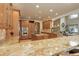 Kitchen showcases a spacious layout, central island cooktop, stainless appliances, and beautiful countertops at 12825 W 81St Ave, Arvada, CO 80005