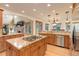 Spacious kitchen with stainless appliances, a large island cooktop, and hardwood floors at 12825 W 81St Ave, Arvada, CO 80005