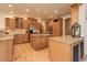 Gourmet kitchen featuring custom cabinetry, stainless steel appliances, granite countertops, and center island at 12825 W 81St Ave, Arvada, CO 80005