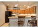 Charming kitchen featuring wood cabinets, granite countertops, and decorative accents at 12825 W 81St Ave, Arvada, CO 80005