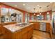Spacious kitchen with granite countertops, a center island cooktop, and stainless steel appliances at 12825 W 81St Ave, Arvada, CO 80005