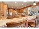 Open-concept kitchen with a breakfast bar, seamless connection to living spaces, and granite countertops at 12825 W 81St Ave, Arvada, CO 80005