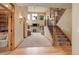 Spacious living room featuring a fireplace, large windows, and staircase with decorative iron railings at 12825 W 81St Ave, Arvada, CO 80005