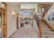 Inviting living room boasts high ceilings, large windows, a cozy fireplace, and elegant sconce lighting at 12825 W 81St Ave, Arvada, CO 80005