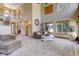 Bright living room with tall ceilings, second-floor balcony, and natural light from large windows at 12825 W 81St Ave, Arvada, CO 80005