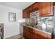 Kitchen features double sink, granite countertops, and wood cabinets at 1313 N Williams St # 703, Denver, CO 80218