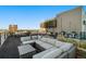 Relaxing rooftop deck with sectional sofa and city views at 1313 N Williams St # 703, Denver, CO 80218