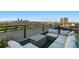City view rooftop deck with sectional sofa and tables at 1313 N Williams St # 703, Denver, CO 80218